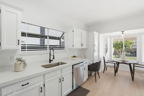 a kitchen with cabinets stainless steel appliances and a counter space