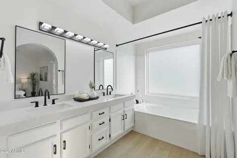 an empty room with a ceiling fan and a window
