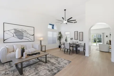 a living room with furniture and a chandelier