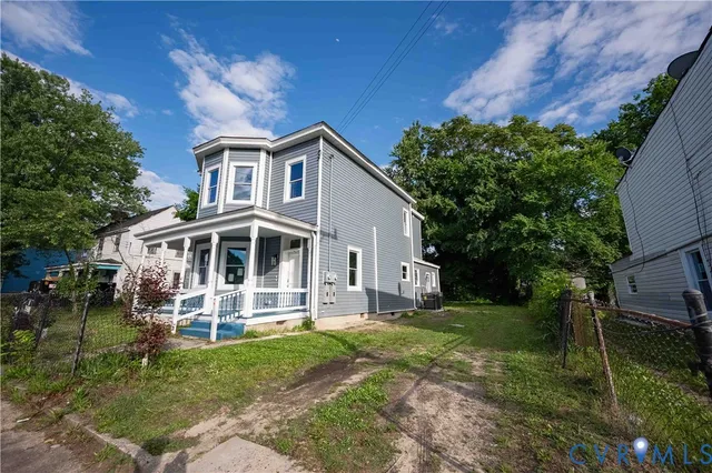 a front view of a house with a yard table and chairs