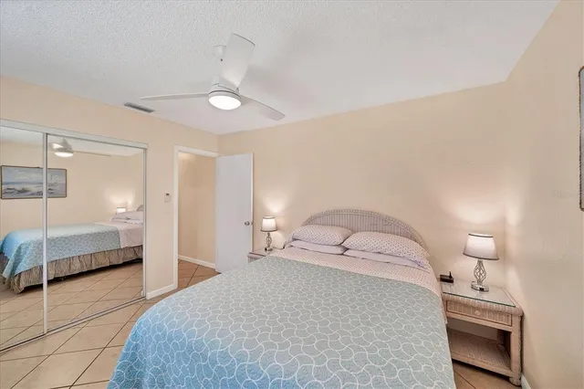 a bedroom with a bed a lamp and a walk in closet