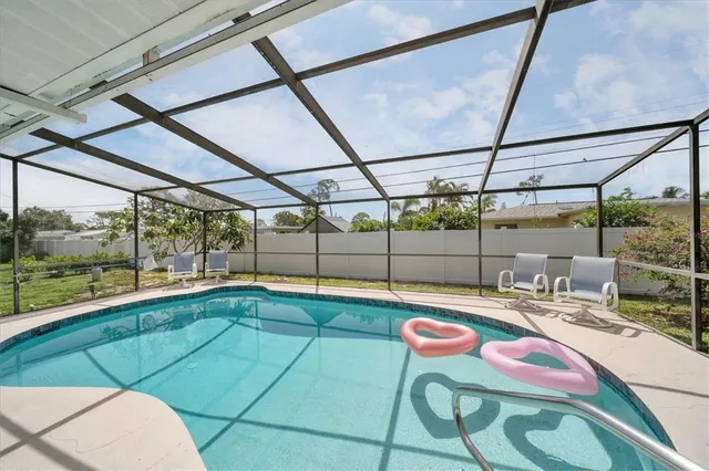a room with pool table and glass windows