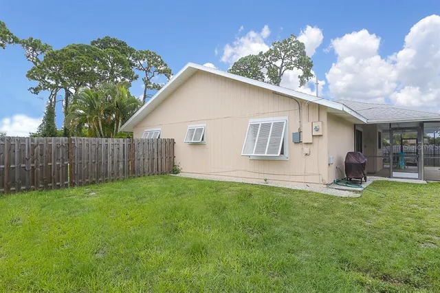 a view of a house with backyard and sitting area