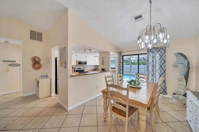 a dining room filled with furniture and chandelier