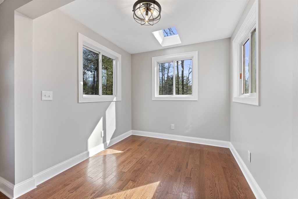224 Three Rivers Road Wilbraham, MA 01095 - Photo 10 of 26 an empty room with wooden floor and windows