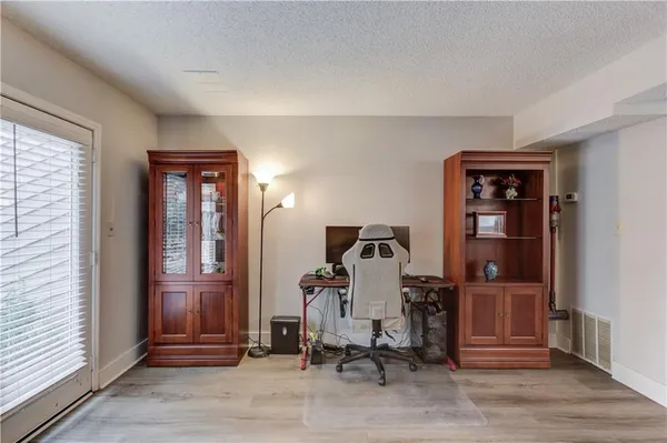a view of a workspace with furniture and closet