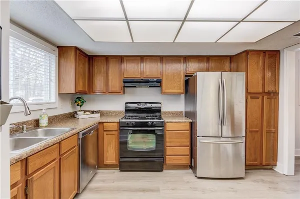 a kitchen with a refrigerator sink and stove
