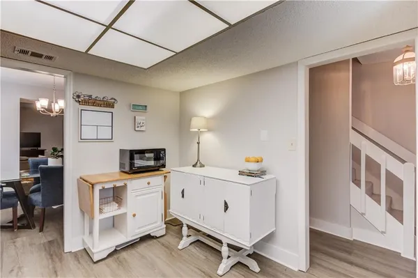 a view of a kitchen with furniture and wooden floor