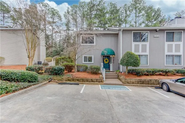 a view of a house with sitting area and garden