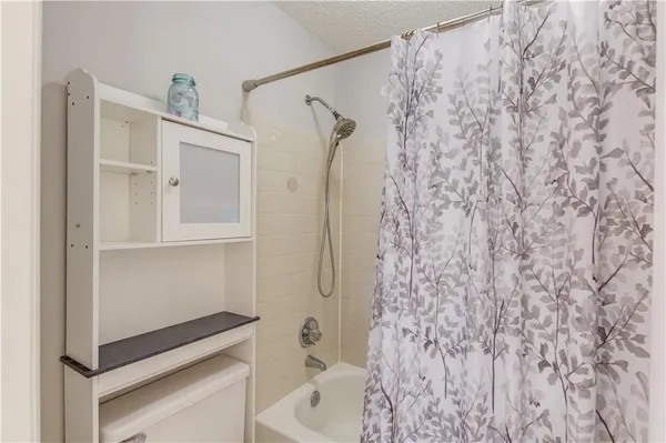 a bathroom with a bathtub and shower