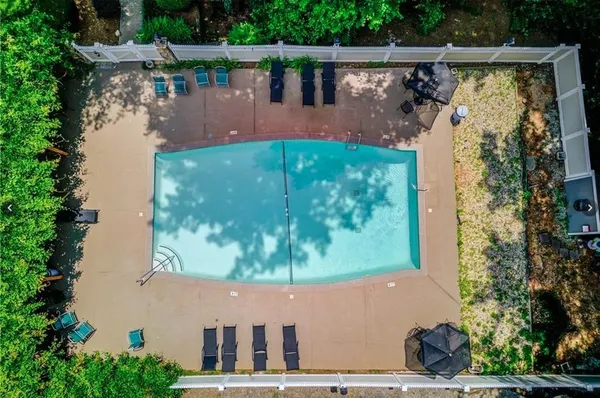 an aerial view of a house with garden space and a lake view