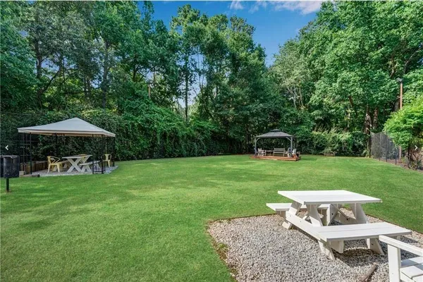 a view of a chair and table on the garden