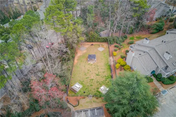 an aerial view of a house with yard