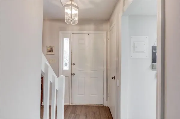a view of a hallway with wooden floor and staircase
