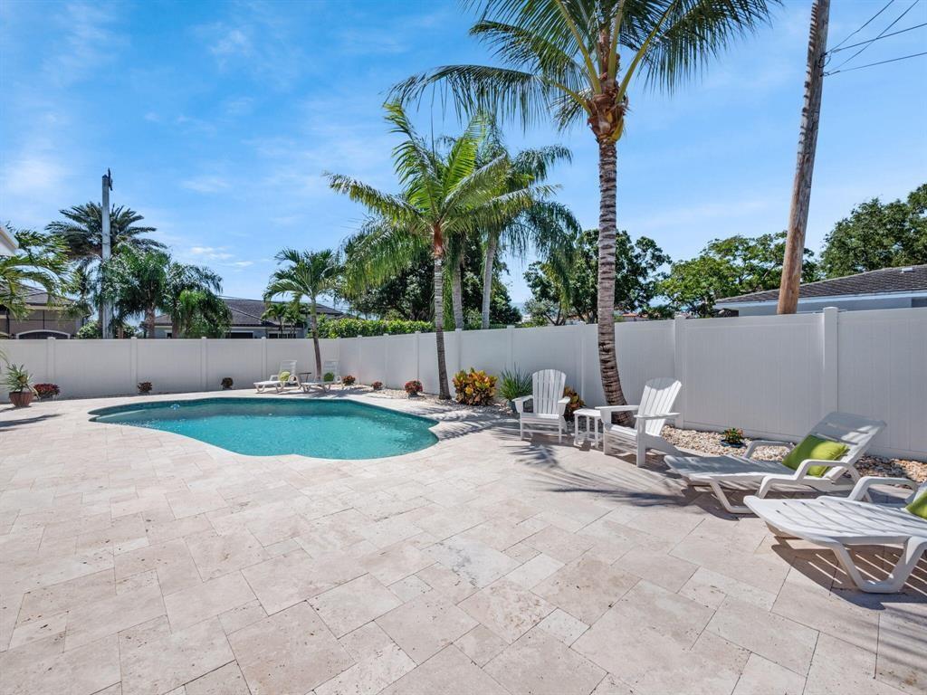 2250 Northeast 35th Street Lighthouse Point, FL 33064 - Photo 11 of 26 a view of swimming pool with a yard and outdoor seating