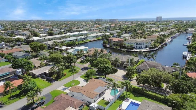 an aerial view of residential houses with outdoor space and river