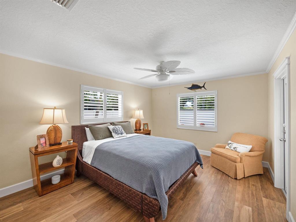 2250 Northeast 35th Street Lighthouse Point, FL 33064 - Photo 21 of 26 a bedroom with a bed and wooden floor