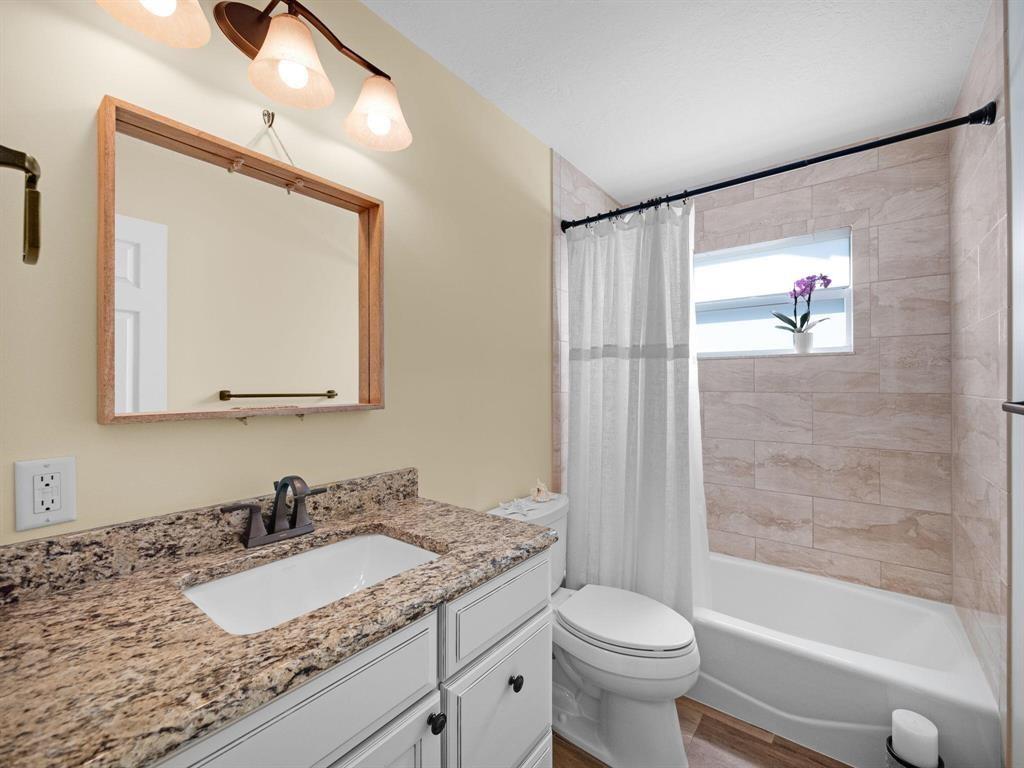 2250 Northeast 35th Street Lighthouse Point, FL 33064 - Photo 23 of 26 a bathroom with a granite countertop sink a toilet and a mirror