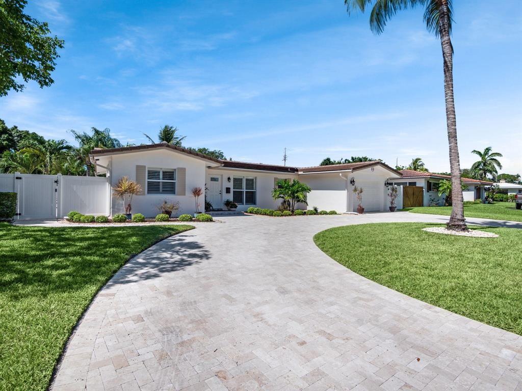 2250 Northeast 35th Street Lighthouse Point, FL 33064 - Photo 24 of 26 a front view of a house with a yard