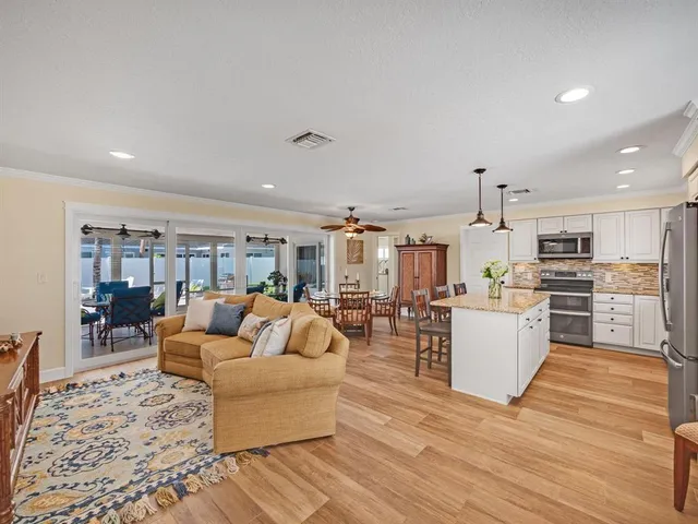 a living room with furniture and kitchen view