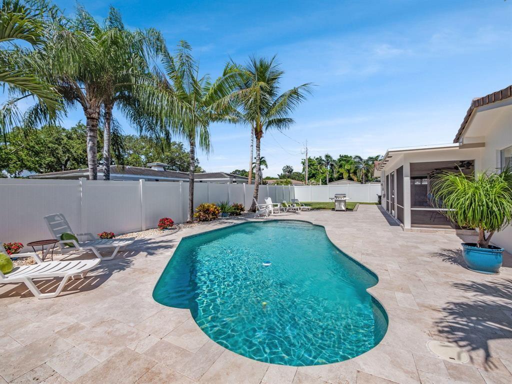 2250 Northeast 35th Street Lighthouse Point, FL 33064 - Photo 9 of 26 a view of a swimming pool with a patio and plants