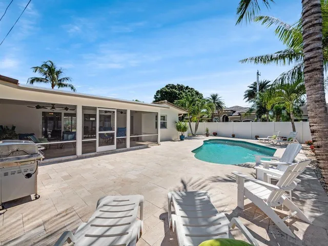 a view of a house with backyard porch and sitting area
