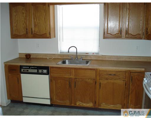 604 Timber Oaks Road Edison, NJ 08820 - Photo 12 of 18 a kitchen with stainless steel appliances granite countertop a sink and cabinets