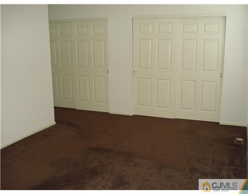 604 Timber Oaks Road Edison, NJ 08820 - Photo 16 of 18 an empty room with wooden floor