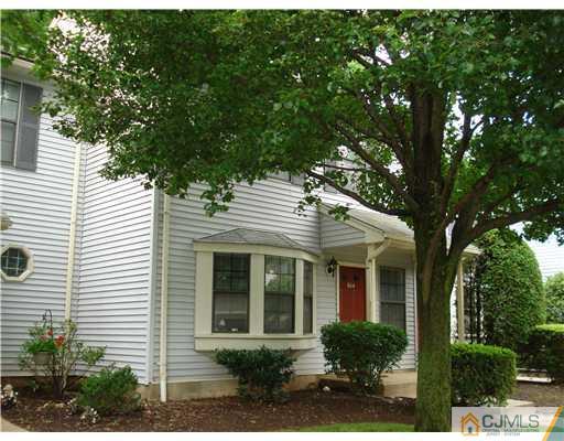 604 Timber Oaks Road Edison, NJ 08820 - Photo 3 of 18 a view of a white house with large windows and a large tree