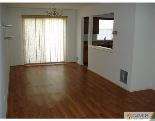 604 Timber Oaks Road Edison, NJ 08820 - Photo 10 of 18 a view of an empty room with wooden floor and a window