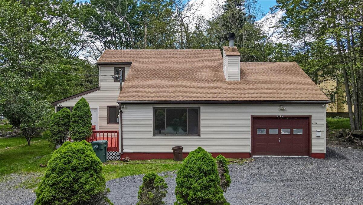 7198 Rimrock Drive Tobyhanna, PA 18466 - Photo 1 of 38 a front view of a house with a yard and garage