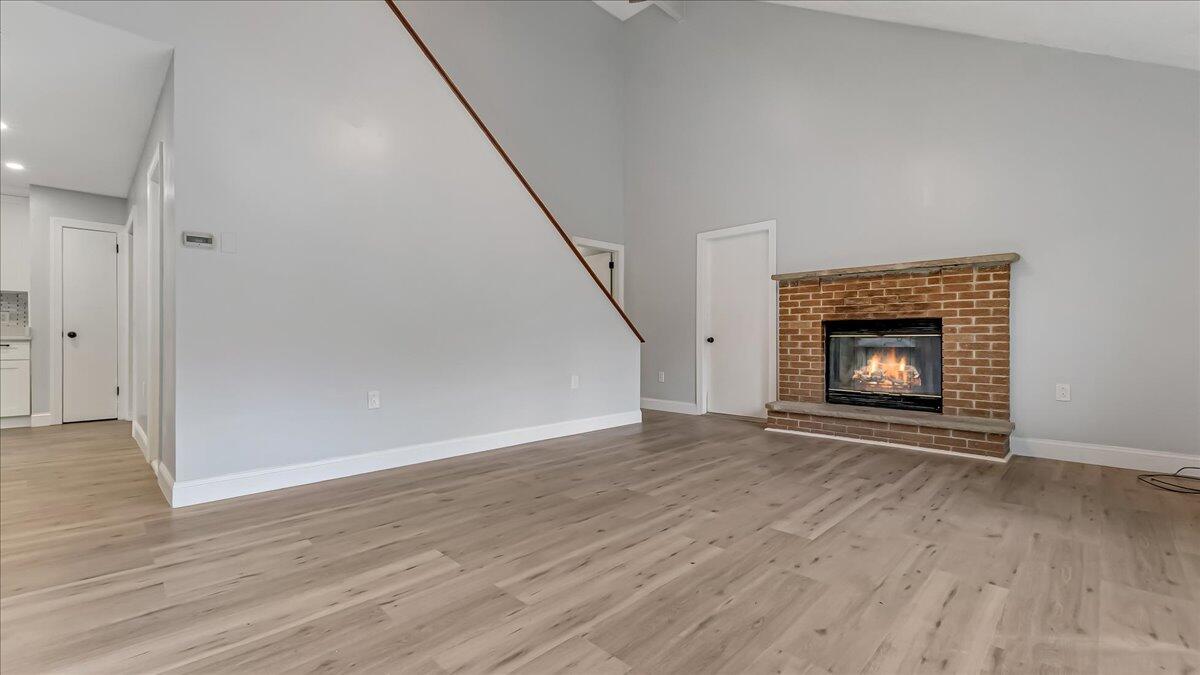 7198 Rimrock Drive Tobyhanna, PA 18466 - Photo 11 of 38 a view of an empty room with wooden floor fireplace and a window