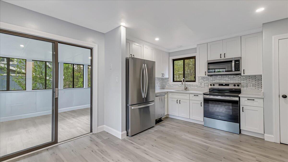 7198 Rimrock Drive Tobyhanna, PA 18466 - Photo 13 of 38 a kitchen with a refrigerator stove and wooden floor