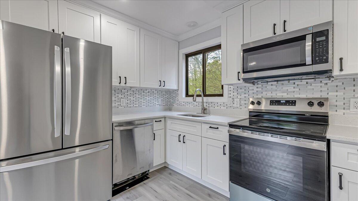 7198 Rimrock Drive Tobyhanna, PA 18466 - Photo 14 of 38 a kitchen with cabinets stainless steel appliances and a sink