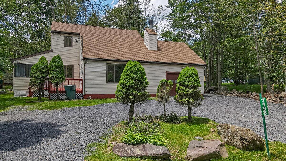 7198 Rimrock Drive Tobyhanna, PA 18466 - Photo 2 of 38 a view of a house with a yard and a garden