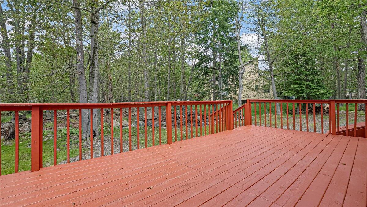 7198 Rimrock Drive Tobyhanna, PA 18466 - Photo 33 of 38 swimming view and deck with wooden floor and fence