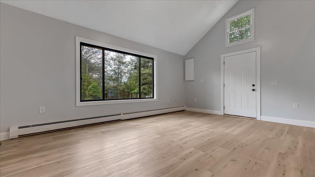 7198 Rimrock Drive Tobyhanna, PA 18466 - Photo 9 of 38 an empty room with wooden floor and windows