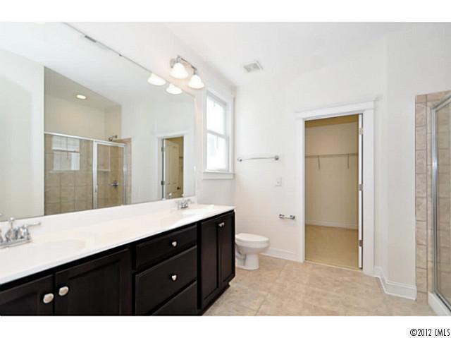 3486 Richard's Crossing Fort Mill, SC 29708 - Photo 13 of 16 a bathroom with a sink a toilet a large mirror and shower