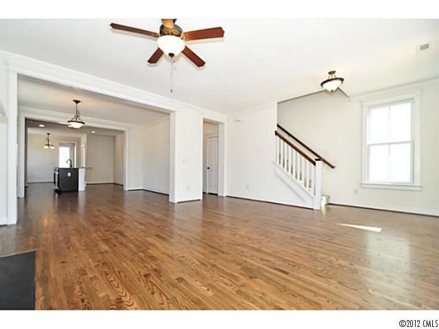 3486 Richard's Crossing Fort Mill, SC 29708 - Photo 5 of 16 a view of an empty room with wooden floor and a ceiling fan
