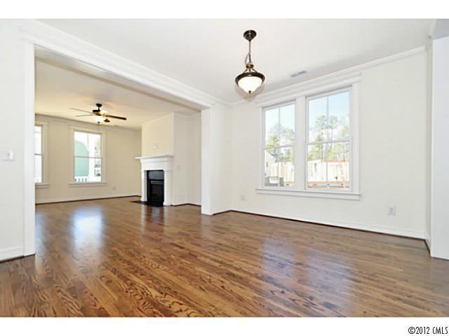3486 Richard's Crossing Fort Mill, SC 29708 - Photo 7 of 16 an empty room with wooden floor chandelier and windows
