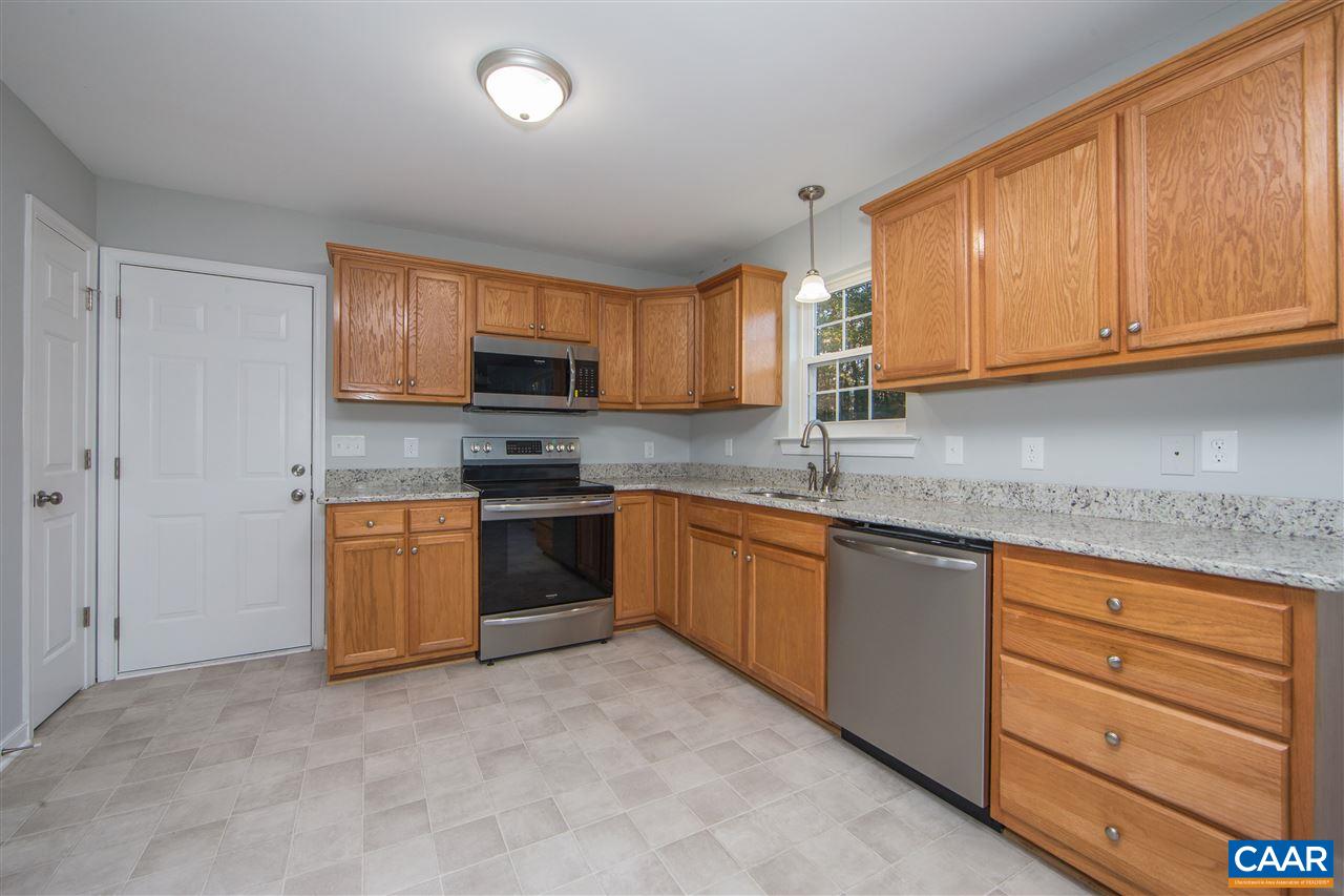 2047 Campbell Road Keswick, VA 22947 - Photo 11 of 39 a kitchen with granite countertop a stove top oven a sink dishwasher and cabinets with wooden floor