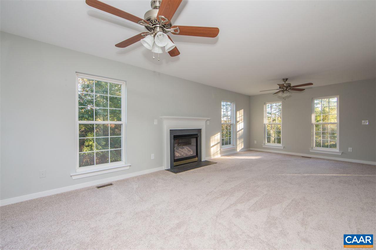 2047 Campbell Road Keswick, VA 22947 - Photo 16 of 39 a view of an empty room with window and chandelier fan