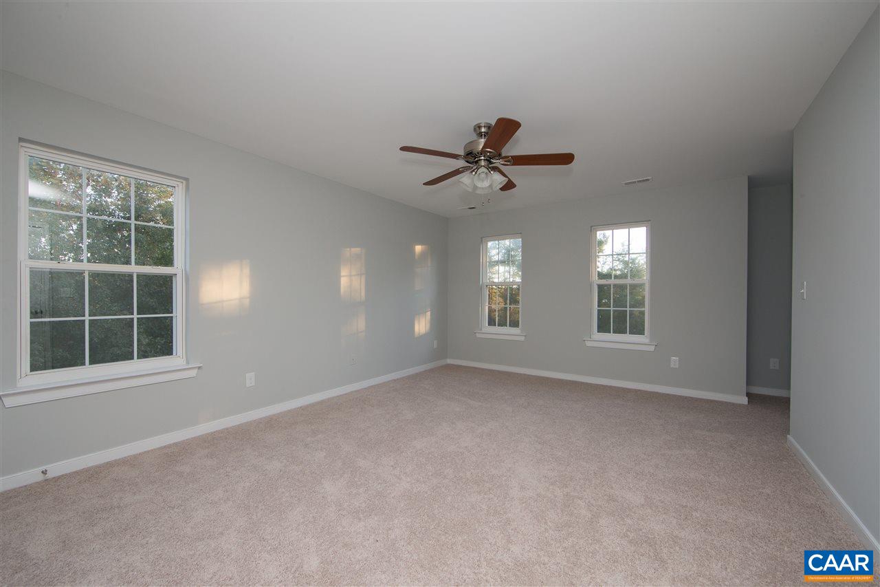 2047 Campbell Road Keswick, VA 22947 - Photo 19 of 39 a view of an empty room with a window and a kitchen