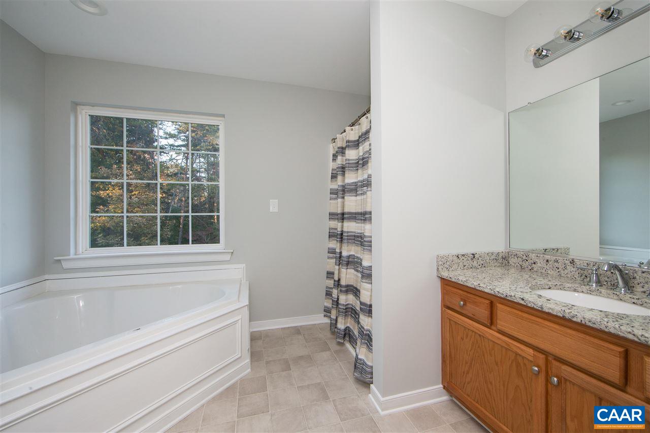 2047 Campbell Road Keswick, VA 22947 - Photo 24 of 39 a bathroom with a granite countertop sink and a bathtub
