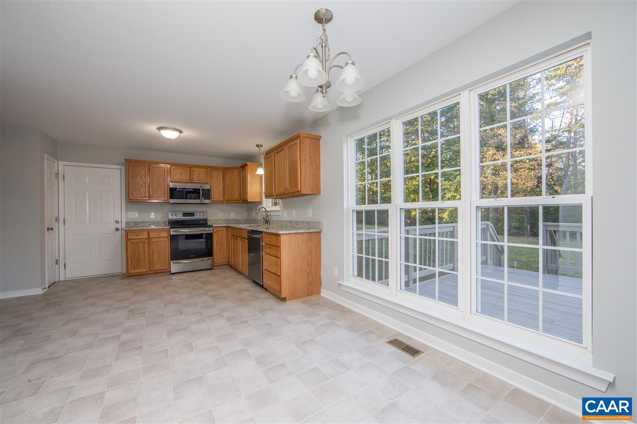 2047 Campbell Road Keswick, VA 22947 - Photo 8 of 39 a open kitchen with cabinets a sink and stainless steel appliances