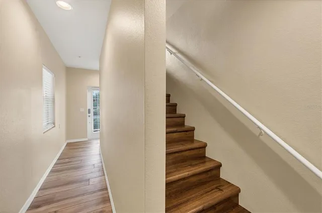 a view of a hallway with wooden floor and entryway
