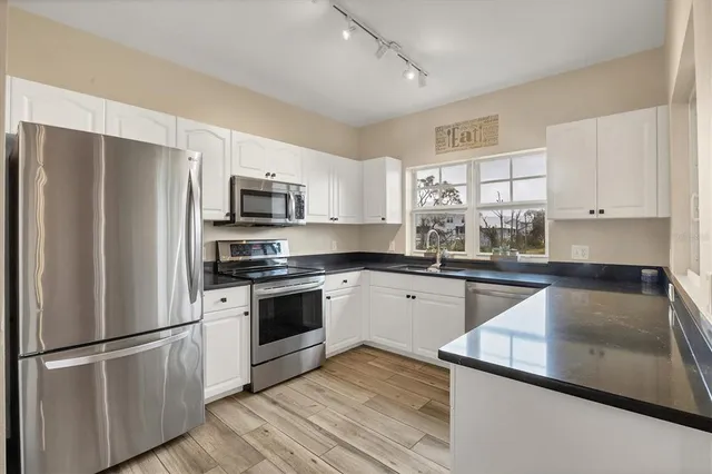 a kitchen with a refrigerator stove and microwave