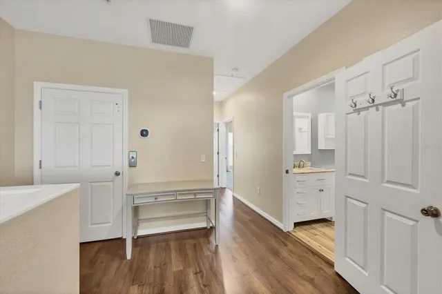 a room view with wooden floor and electronic appliances