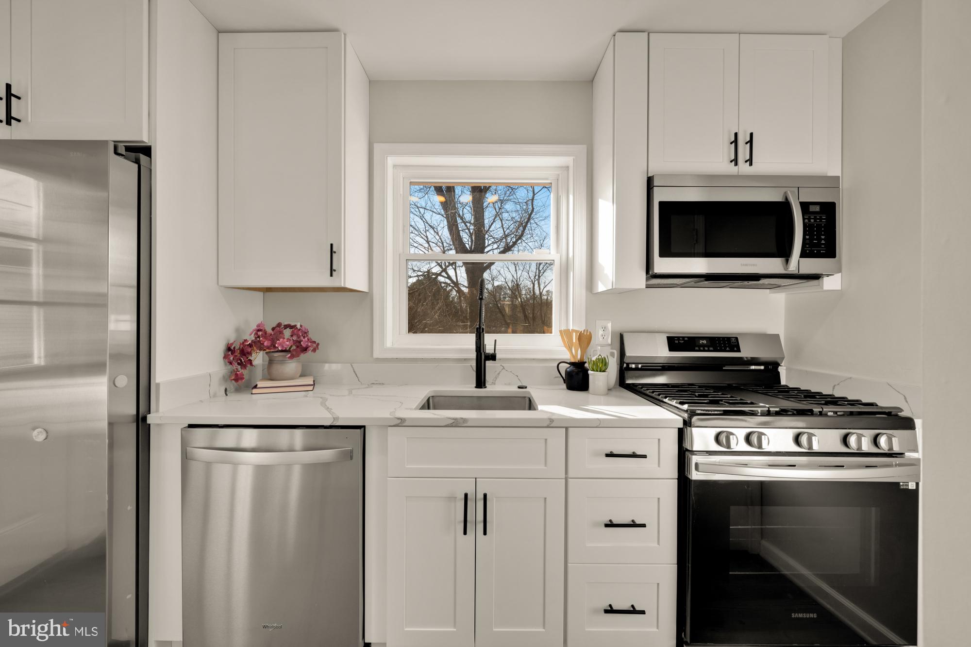 6112 Paulonia Road Alexandria, VA 22310 - Photo 15 of 48 a kitchen with stainless steel appliances a stove microwave and cabinets