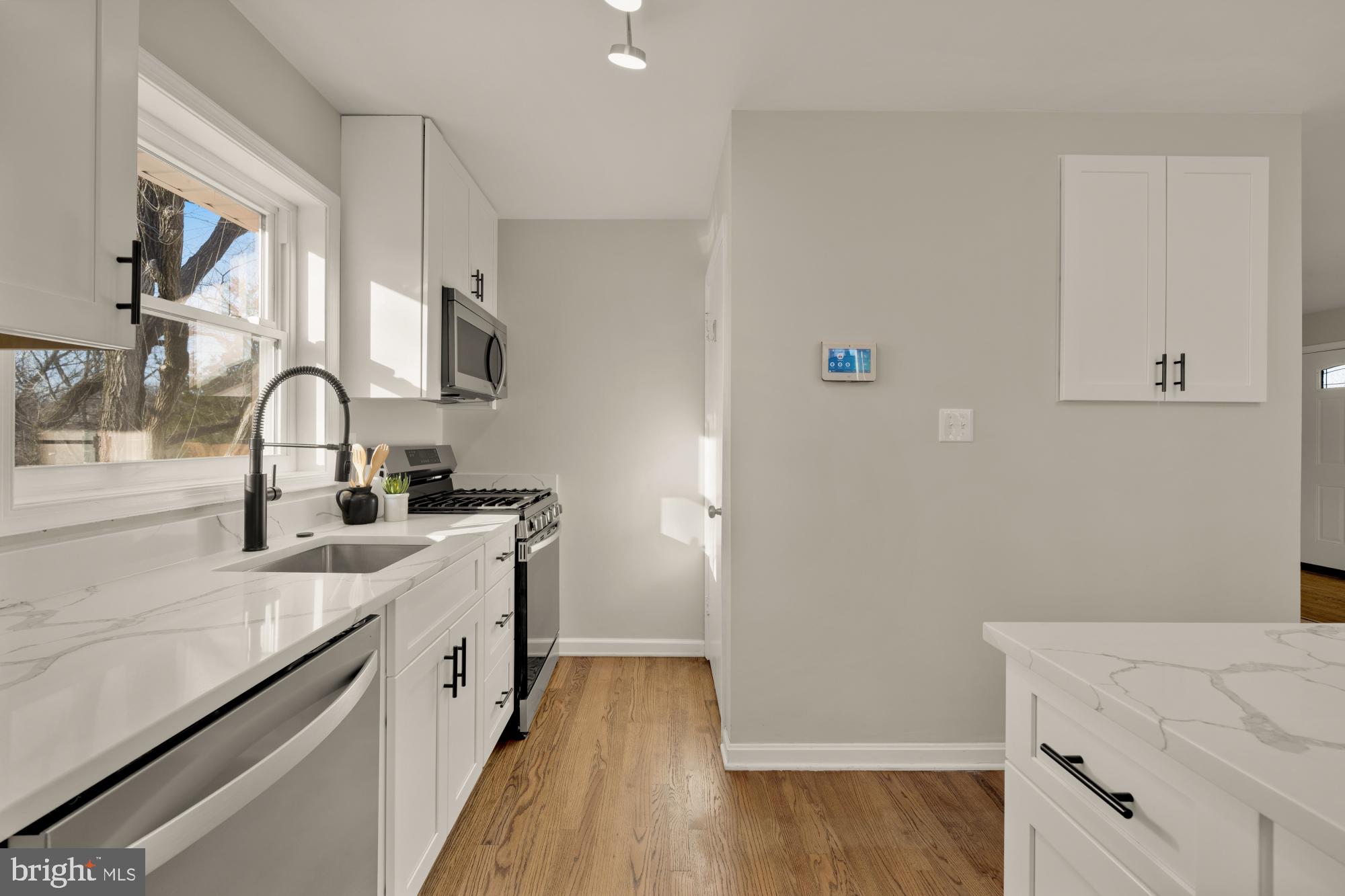 6112 Paulonia Road Alexandria, VA 22310 - Photo 17 of 48 a kitchen with a sink and a stove top oven with wooden floor